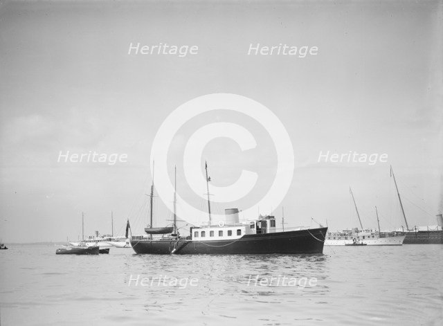 The twin screw 80ft motor yacht 'Bystander' at anchor, 1934. Creator: Kirk & Sons of Cowes.