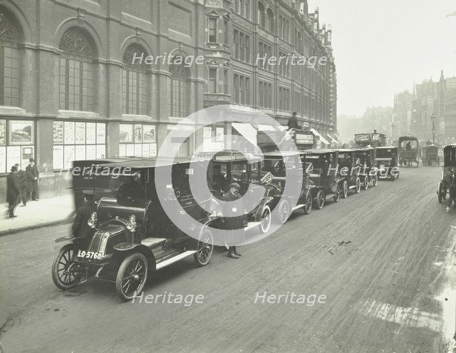 Hackney carriages and drivers at a taxi rank, Bishopsgate, London, 1912. Artist: Unknown.
