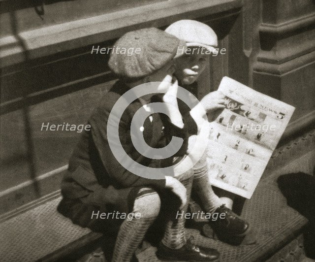 Two boys reading the comic section of the Sunday paper, New York, USA, 1931. Artist: Unknown