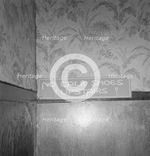 Sign on staircase on Brooks Hotel in a town..., West Carlton, Yamhill County, Oregon, 1939. Creator: Dorothea Lange.