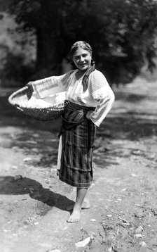Woman carrying a large basket, Bistrita Valley, Moldavia, north-east Romania, c1920-c1945. Artist: Adolph Chevalier