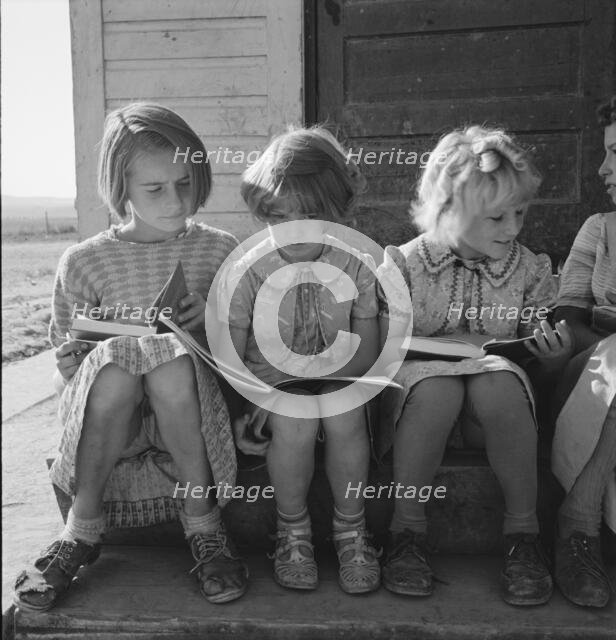 Girls of Lincoln Bench School study their reading lesson, near Ontario, Malheur County, Oregon, 1939 Creator: Dorothea Lange.