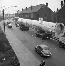 An absorption tower being transported by road, Dukenfield, Manchester, 1962. Artist: Michael Walters