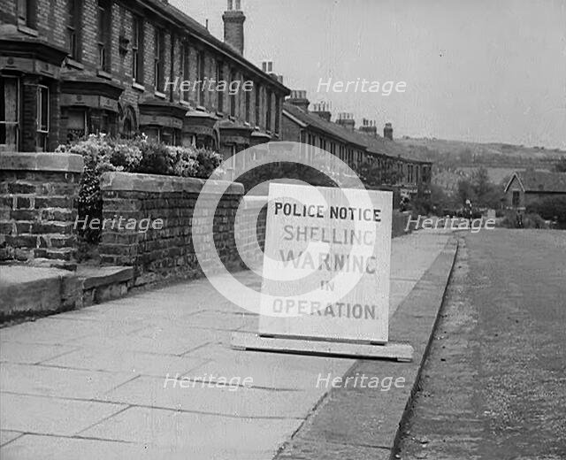 A Police Warning Notice of German Shelling, 1940. Creator: British Pathe Ltd.