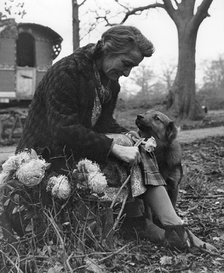 Gypsy woman with dog, 1960s.
