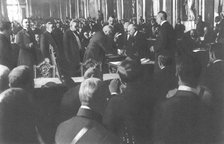 'La signature du traite de paix a Versailles; M Clemenceau signe debout: derriere..., 1919. Creator: Unknown.
