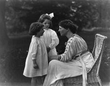 Mrs. Frank Vanderlip seated on porch, with two children, not after 1913. Creator: Frances Benjamin Johnston.