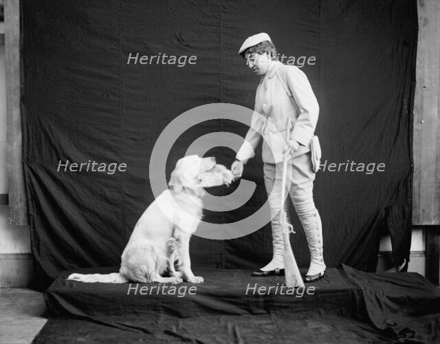 Billy and his mistress in hunting poses, between 1895 and 1910. Creator: Unknown.