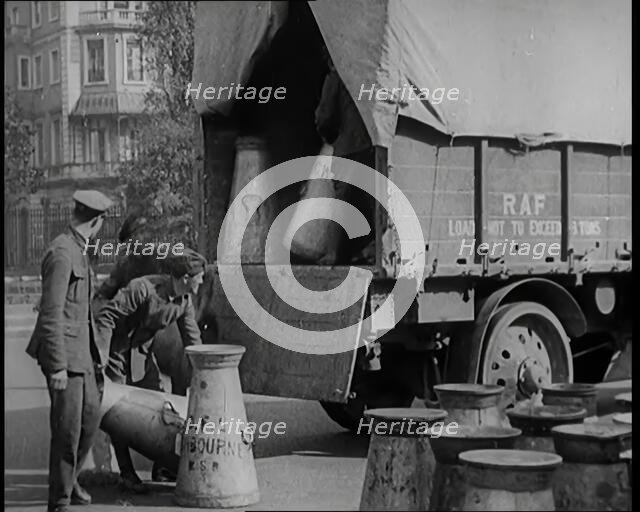 Milk Churns Being Loaded Onto a Lorry by Male Soldiers, 1926. Creator: British Pathe Ltd.