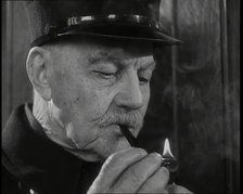 Close up on Male British Chelsea Pensioner as He is Lighting a Pipe, 1939. Creator: British Pathe Ltd.