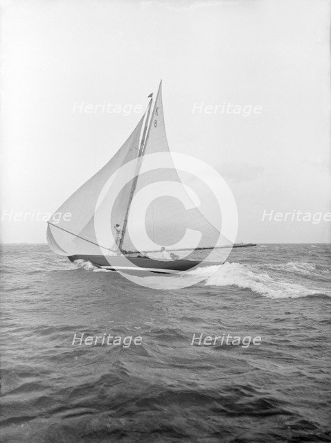 The 7 Metre yacht 'Pinaster' (K8) sailing with spinnaker, 1913. Creator: Kirk & Sons of Cowes.