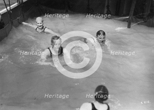 Passengers in the swimming pool on board a cruise ship, c1920s-c1930s(?). Artist: Unknown