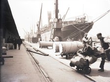 Unloading rolls of paper from a ship, London, c1905. Artist: Unknown