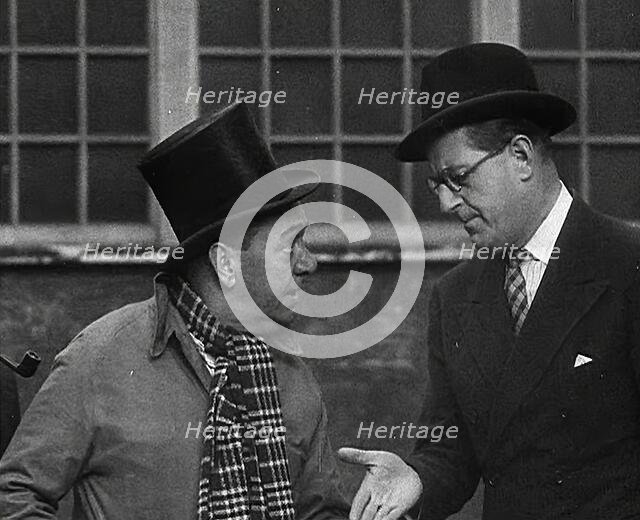Syd Walker Talking to Stanley Holloway About Using gramophone records for War Materials, 1942. Creator: British Pathe Ltd.