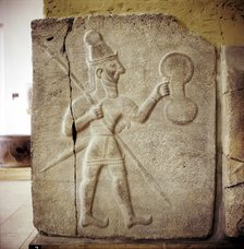 Hittite relef of a Hittite warrior or war-god with shield spear and sword. Artist: Unknown