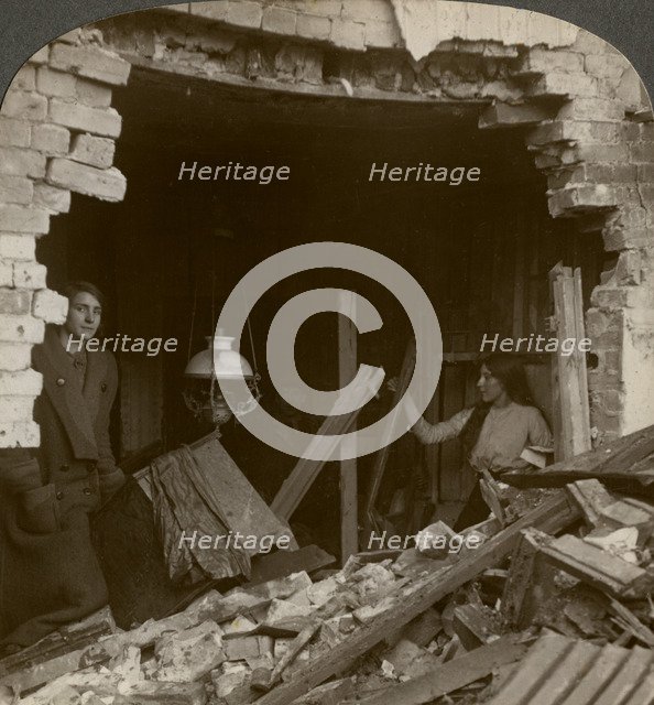 The damage done by a German Zeppelin bomb, World War I, 1914-1918.Artist: Realistic Travels Publishers