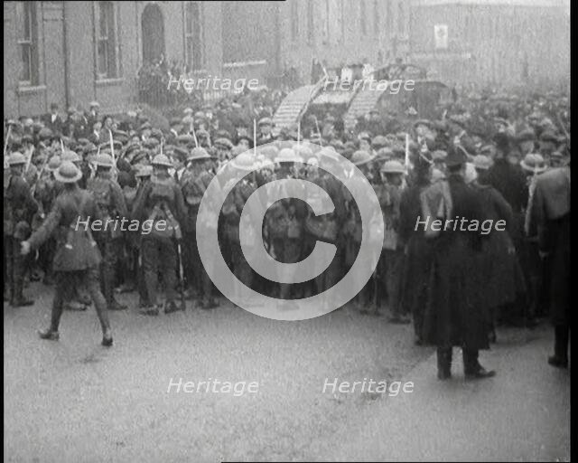 British Soldiers Holding Back Crowds of Demonstrators in Dublin as a Tank Moves Through to..., 1920. Creator: British Pathe Ltd.