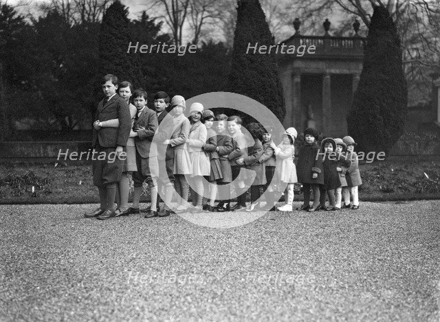 Cavendish family group of 16 grandchildren in the gardens of Chatsworth, Derbyshire, Christmas 1929. Artist: JR Board