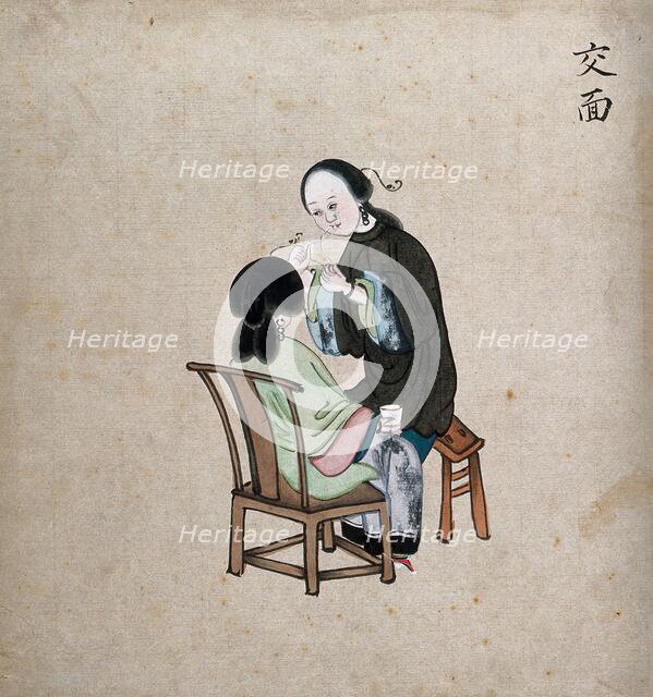 A standing woman preparing to remove facial hair from seated woman using a piece of string, 1800-99. Creator: Unknown.