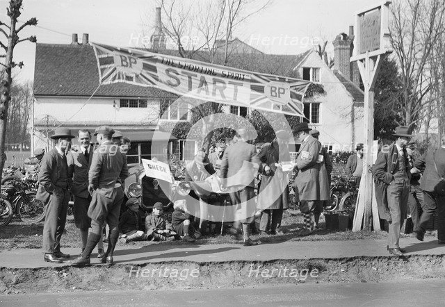 Start line for the Surbiton Motor Club Grand Cup, the Talbot Hotel, Ripley, Surrey, 1929. Artist: Bill Brunell.