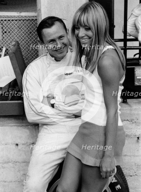 Bruce McLaren with female admirer in the pits, 1967 Italian Grand Prix. Creator: Unknown.