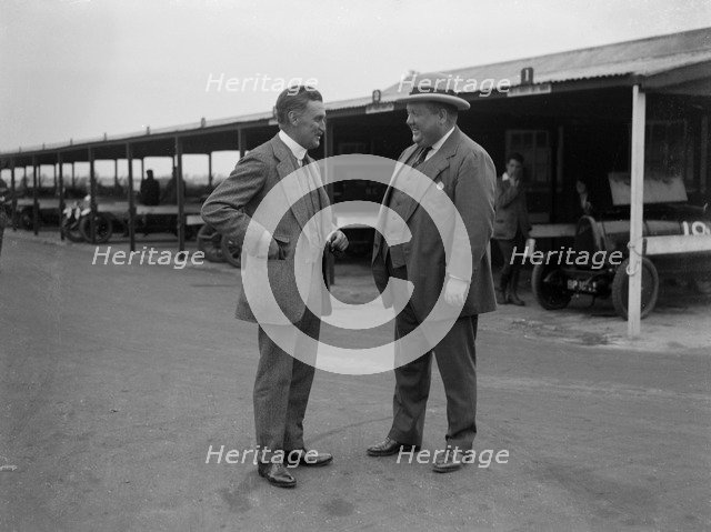 Two men chatting at Brooklands motor racing circuit, Surrey, 1920s. Artist: Bill Brunell.