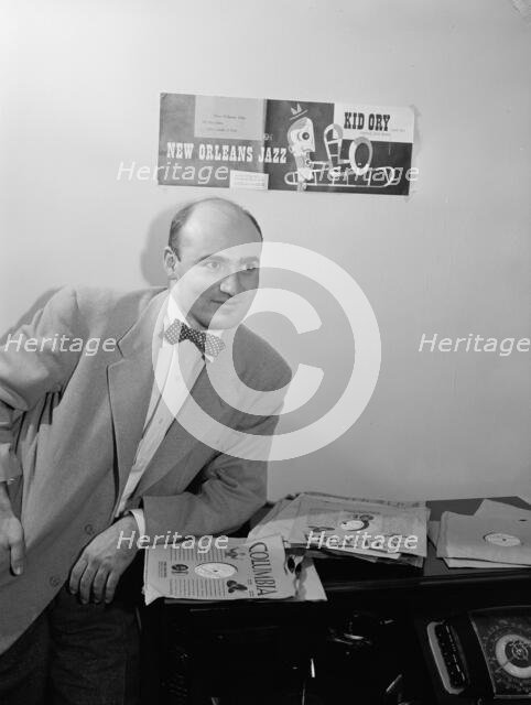 Portrait of George Avakian in his office or home, New York, N.Y.(?), 1938. Creator: William Paul Gottlieb.