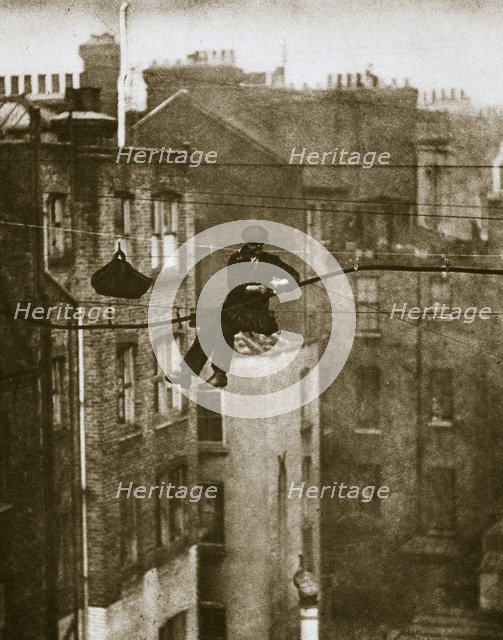 Inspecting a telephone cable between Conduit and Maddox Streets, 20th century. Artist: Unknown