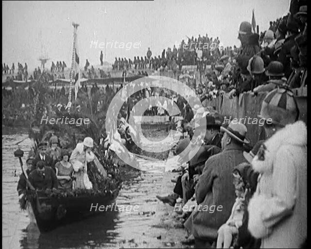 Civilians on the Margin of a River Throwing Flowers to  Civilians on a Boat Heavily Decorated...1920 Creator: British Pathe Ltd.