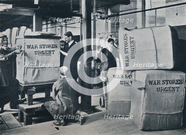 Packing the bales of khaki for despatch to the Government, c1914. Artist: Unknown