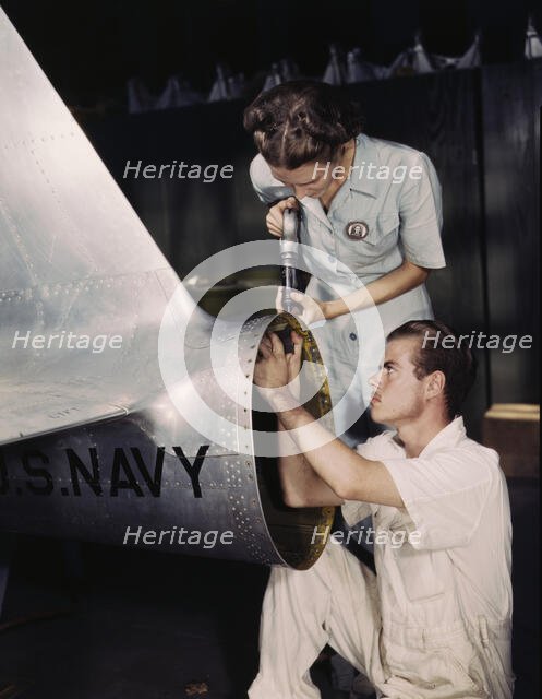 Mrs. Virginia Davis, a riveter in the assembly and repair department of the Naval Air Base..., 1942. Creator: Howard Hollem.