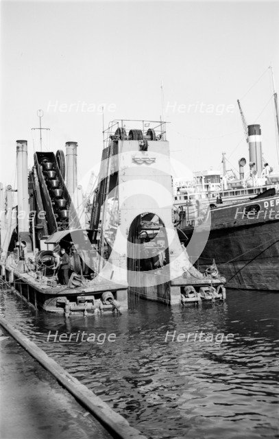 A dredger at work in Tilbury Docks, Essex, c1945-c1965.  Artist: SW Rawlings