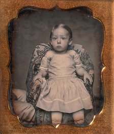 Child Sitting on Chair Draped with Floral Print Fabric, 1850s. Creator: Unknown.