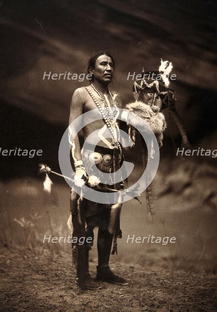 A Navajo man in ceremonial dress representing the Yebichai god Zahabolzi (Zahadolzha?), 1904. Creator: Edward Sheriff Curtis.