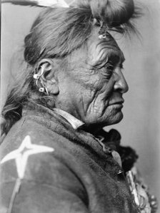 Hoop On the Forehead, Crow Indian, Montana, head-and-shoulders portrait, facing right, c1908. Creator: Edward Sheriff Curtis.