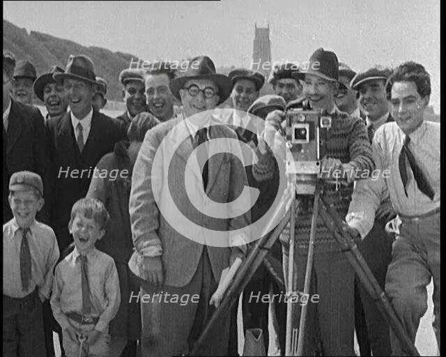 A Group of People Laughing as They Are Watch the Film Being Made from Behind a Camera, 1920s. Creator: British Pathe Ltd.