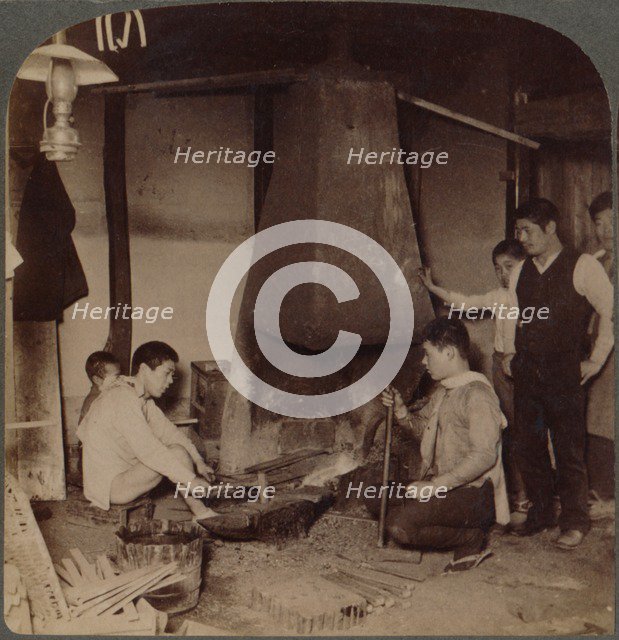 'A Japanese blacksmith at his forge, Yokohama, Japan', 1904. Artist: Unknown.