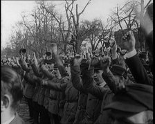 Group of Male Civilians Standing and Cheering With Their Fists Raised in the Air, 1924. Creator: British Pathe Ltd.