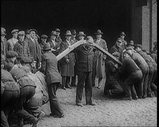 A Male Stuntman Bending Girders Over His Shoulders, 1926. Creator: British Pathe Ltd.