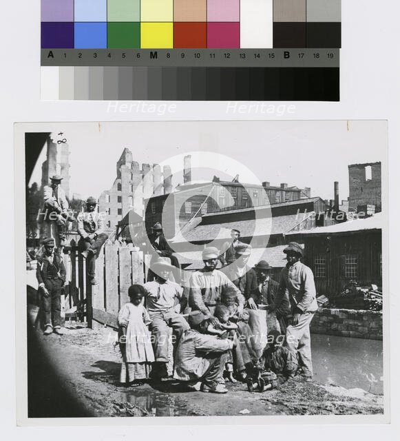 Group of freedmen, including children, gathered by a canal in Richmond, Virginia, c1865. Creator: Unknown.