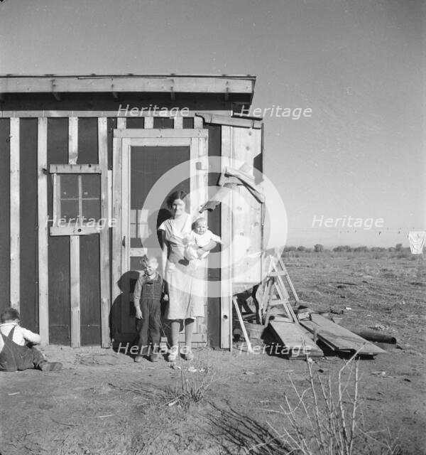 Resettled at Bosque Farms project - family of four from Taos Junction, 1935. Creator: Dorothea Lange.