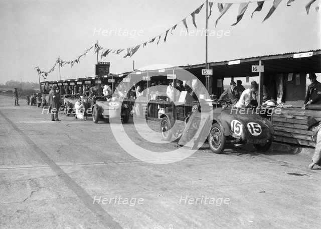 Talbot 105 and Lea-Francis cars in the pits at the JCC Double Twelve race, Brooklands, 8/9 May 1931. Artist: Bill Brunell.
