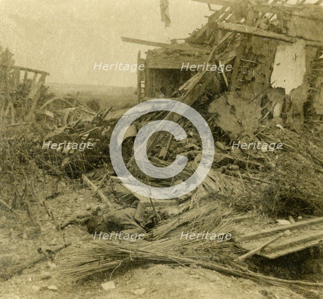Bombed out building, body of dead soldier in foreground, 1916. Artist: Unknown.