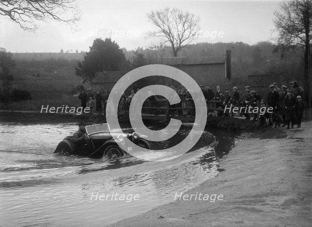 MG PA driving through a ford during a motoring trial, 1936. Artist: Bill Brunell.