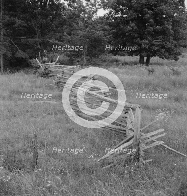 Rail fence with poor barbed wire fence in foreground, Person County, North Carolina, 1939. Creator: Dorothea Lange.