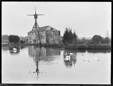 West Ashling Mill from north-west across the mill pond, Mill Road, Funtington, West Sussex, 1920-50. Creator: George R Long.