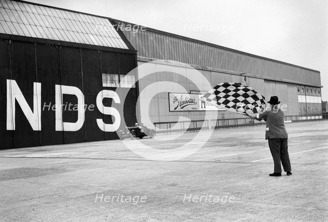 Waving the chequered flag at Brooklands, 1938 or 1939. Artist: Bill Brunell.