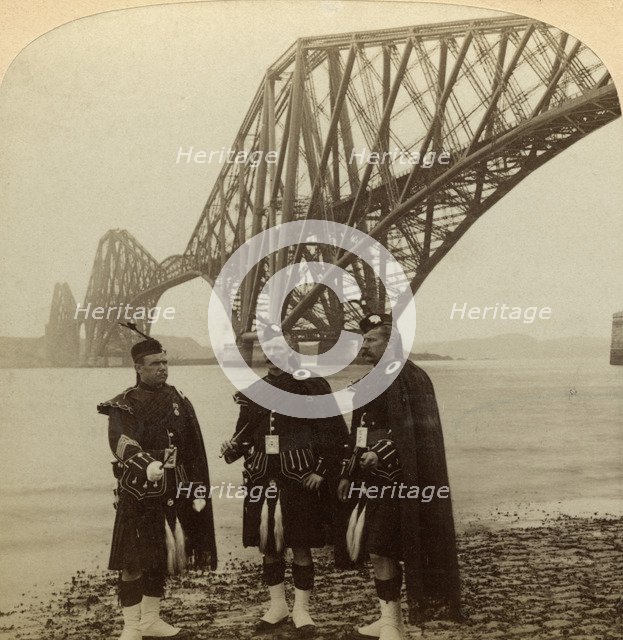 Men in Highland dress in front of the Forth Bridge, Scotland.Artist: Underwood & Underwood