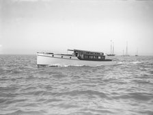 The motor launch 'Cygnet' under way, 1912. Creator: Kirk & Sons of Cowes.