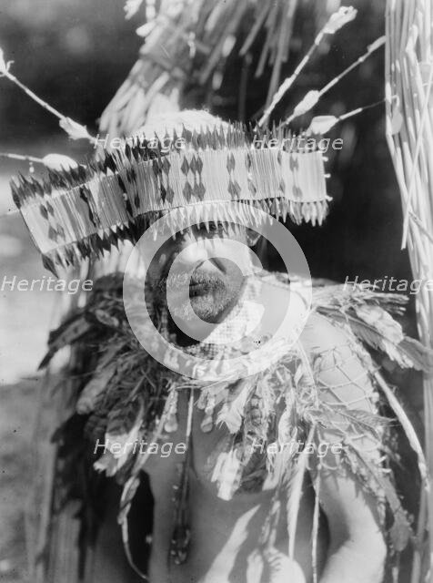 Man in Pomo dance costume, half-length portrait, facing front, c1924. Creator: Edward Sheriff Curtis.